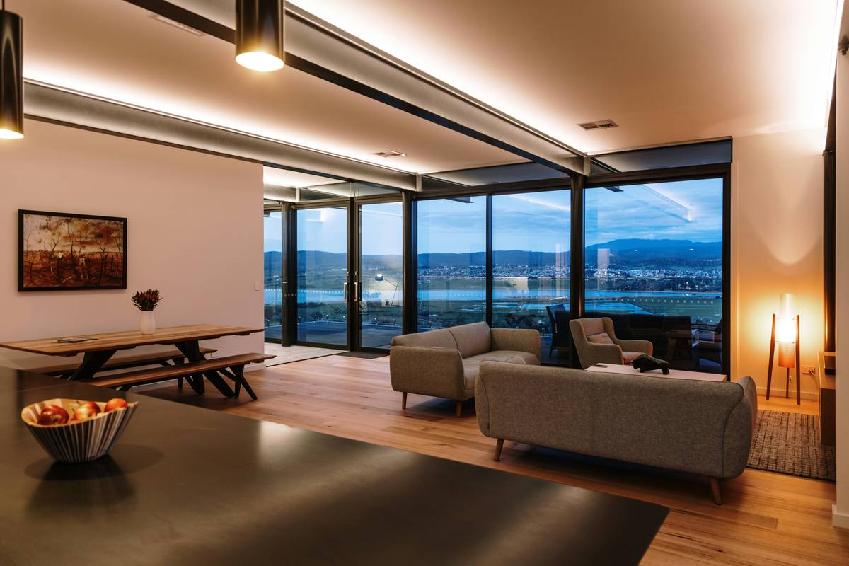 Modern kitchen with residential track lighting fixtures highlighting countertops and island